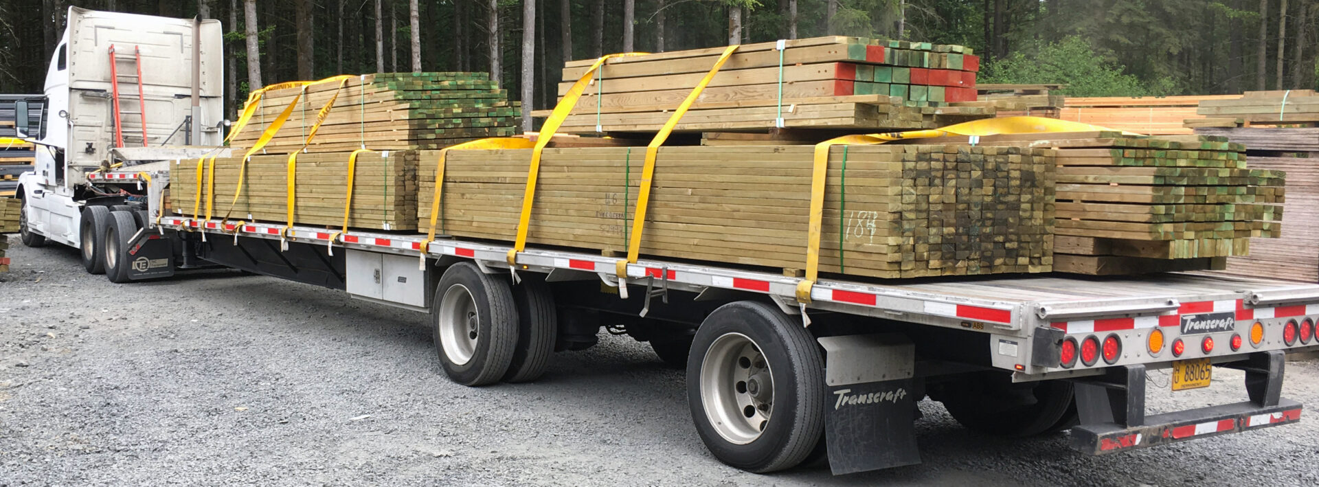 A truck with wooden planks on the back of it.
