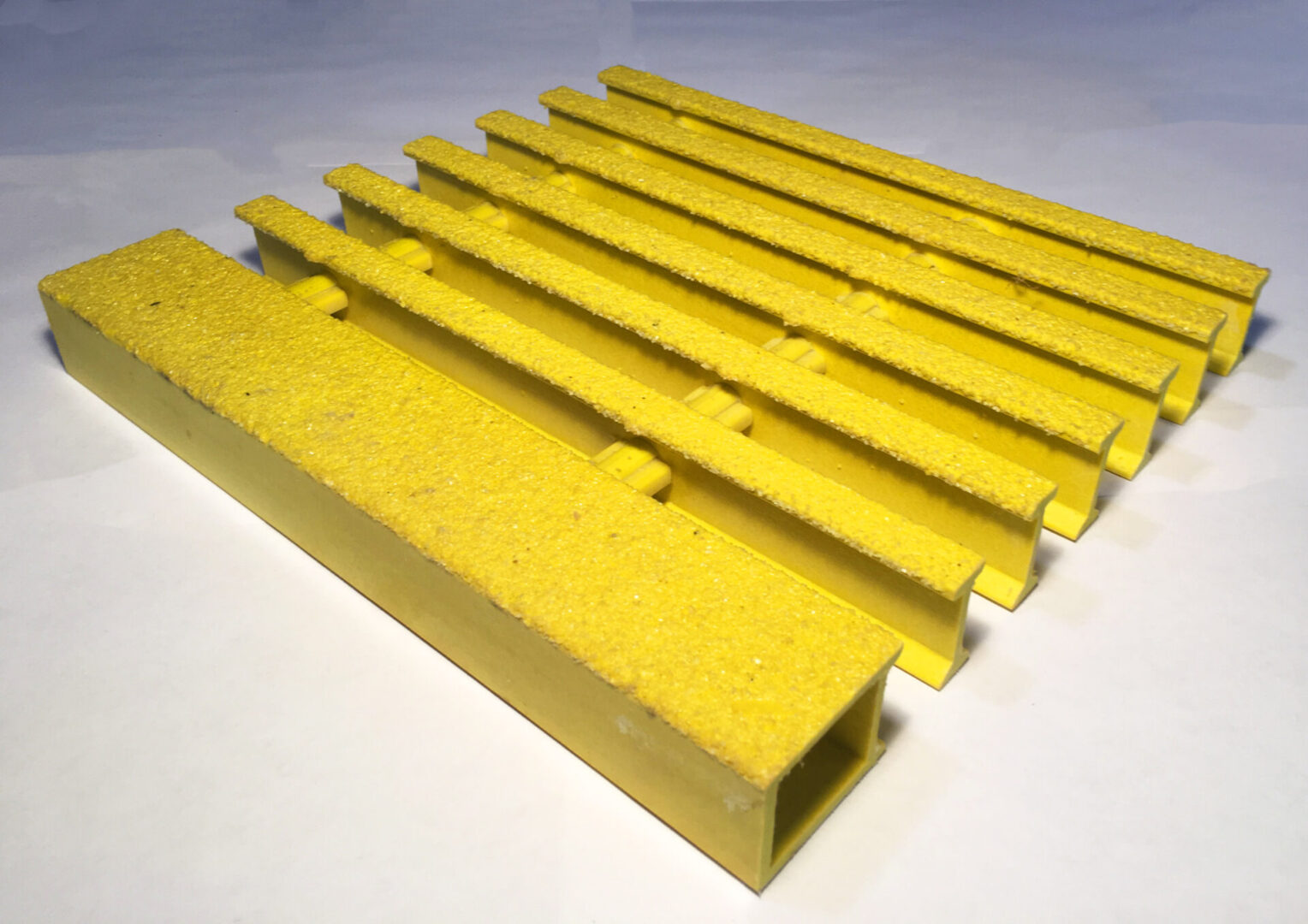 A yellow plastic bar with some holes in it